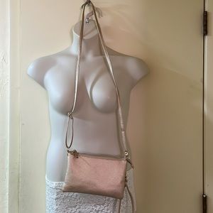 Rose gold wristlet purse never used.Paper removed from strap.Small for my needs.